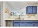 Kitchen view with blue cabinets, marble countertops and stainless dishwasher at 107 Sturbridge Dr, Clayton, NC 27520