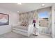 Well-lit bedroom featuring wallpaper accent, a daybed, and a round accent table at 1080 River Glade Ct # 17, Graham, NC 27253