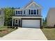 Charming two-story home with gray siding, stone accents, and a spacious two-car garage at 1080 River Glade Ct # 17, Graham, NC 27253