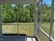 Relaxing screened porch providing a serene view of the lush backyard at 1080 River Glade Ct # 17, Graham, NC 27253