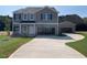 Two-story home featuring a covered carport and a detached garage on a large landscaped lawn at 109 Sagamore Avenue, Angier, NC 27501