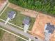 A high-angle view showcases a landscaped property among new constructions, highlighting its curb appeal and convenient location at 1112 Prominence Dr, Durham, NC 27712