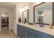 Bathroom featuring double vanity with gray cabinets, a 'Blessed' sign, and a walk in closet at 1112 Prominence Dr, Durham, NC 27712