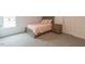 Bedroom featuring gray carpet, a window and a bed with pink and white patterned bedding at 1112 Prominence Dr, Durham, NC 27712