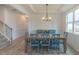 Elegant dining room featuring a wood table with blue chairs and coffered ceilings at 1112 Prominence Dr, Durham, NC 27712
