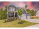 Charming two-story home with inviting front porch, manicured lawn, and three-car garage at 1112 Prominence Dr, Durham, NC 27712
