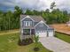 Aerial view of a beautiful home with a well-manicured lawn and a spacious three-car garage at 1112 Prominence Dr, Durham, NC 27712