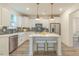 Modern kitchen with white cabinets, stainless steel appliances, and a stylish island with seating at 1112 Prominence Dr, Durham, NC 27712