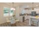 Bright kitchen with white cabinetry, modern appliances, and an adjacent breakfast nook at 1112 Prominence Dr, Durham, NC 27712