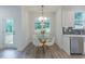 Cozy kitchen nook with a round glass table and modern chairs by large windows at 1112 Prominence Dr, Durham, NC 27712