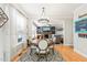 Elegant dining area with a chandelier, and views into a comfortable living room with a fireplace at 112 Nelson Ln, Clayton, NC 27527