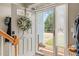 View through open front door with wreath, showing an entryway with a glimpse of the landscaped front yard at 112 Nelson Ln, Clayton, NC 27527