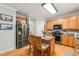 Well-lit kitchen with a central island, stainless steel refrigerator, and plenty of cabinet space at 112 Nelson Ln, Clayton, NC 27527