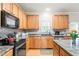 Modern kitchen featuring stainless steel appliances, granite countertops, and ample cabinet storage at 112 Nelson Ln, Clayton, NC 27527
