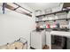 Functional laundry room with stainless steel shelving and a modern washer and dryer at 112 Nelson Ln, Clayton, NC 27527