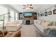 Comfortable living room with a stone fireplace, built-in shelves, and plush seating for relaxing at 112 Nelson Ln, Clayton, NC 27527