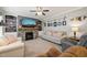 Cozy living room with a stone fireplace, built-in shelves, and inviting seating arrangement at 112 Nelson Ln, Clayton, NC 27527