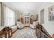 Bright living room with elegant chandelier, stylish armchairs, decorative bookcase, and a patterned area rug at 112 Nelson Ln, Clayton, NC 27527