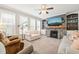 Bright living room featuring a fireplace, large windows, and neutral decor for a comfortable atmosphere at 112 Nelson Ln, Clayton, NC 27527