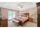 Spacious main bedroom with tray ceiling, a ceiling fan, and access to a private balcony at 112 Nelson Ln, Clayton, NC 27527