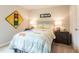 Bedroom with neutral colored walls and bed with lamps on either side at 112 Sagamore Avenue, Angier, NC 27501