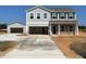Two-story home with an attached and detached garage, and a concrete driveway on a sunny day at 112 Sagamore Avenue, Angier, NC 27501