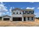 New two-story home with attached garage and detached garage on a large lot ready for landscaping at 112 Sagamore Avenue, Angier, NC 27501
