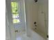 Bathroom showcasing a shower-tub combination and neutral tile at 118 Hawthorn Dr, Clayton, NC 27520