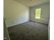 Bedroom with neutral carpet, bright window, and closet at 118 Hawthorn Dr, Clayton, NC 27520