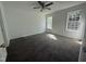 Bedroom featuring neutral carpet, two windows, and ample natural light at 118 Hawthorn Dr, Clayton, NC 27520