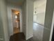 Bright bedroom features connecting bathroom and grey wood flooring at 118 Hawthorn Dr, Clayton, NC 27520