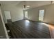 Open living room features vaulted ceiling, fan, and door to the yard at 118 Hawthorn Dr, Clayton, NC 27520