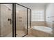 Bathroom showcasing tiled walk-in shower and soaking tub at 1212 Sand Pine Dr, Cary, NC 27519
