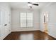 Bright bedroom with a ceiling fan, hardwood floors, a window, and white trim at 1212 Sand Pine Dr, Cary, NC 27519