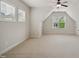 Spacious bonus room featuring neutral carpet, a ceiling fan and two large windows at 1212 Sand Pine Dr, Cary, NC 27519
