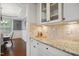 Charming kitchen featuring granite countertops, tile backsplash, and modern white cabinetry at 1212 Sand Pine Dr, Cary, NC 27519