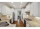 Bright kitchen features granite countertops, stainless steel appliances, and ample white cabinetry at 1212 Sand Pine Dr, Cary, NC 27519