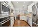 Modern kitchen with stainless steel appliances, granite countertops, and ample cabinet space at 1212 Sand Pine Dr, Cary, NC 27519