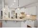 Bright kitchen featuring granite countertops, white cabinets, and stainless steel appliances at 1212 Sand Pine Dr, Cary, NC 27519