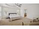 Spacious main bedroom featuring tray ceiling, carpet, and ensuite bathroom at 1212 Sand Pine Dr, Cary, NC 27519