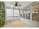 Screened porch with wood flooring, ceiling fan, and bright, natural light at 1212 Sand Pine Dr, Cary, NC 27519