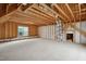 Unfinished space showcasing exposed wood beams and a window for natural light at 1212 Sand Pine Dr, Cary, NC 27519