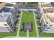Aerial view of neighborhood with lawn, walkways, outdoor furniture, and newly built buildings at 1238 Coach Station Aly # 101, Raleigh, NC 27601