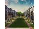 This aerial view showcases townhomes surrounding a green space, connecting residents and fostering community engagement at 1238 Coach Station Aly # 101, Raleigh, NC 27601
