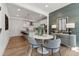 Dining area next to the kitchen featuring hardwood floors, stylish lighting, and seating for four people at 1238 Coach Station Aly # 101, Raleigh, NC 27601