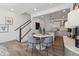 Stylish dining area with seating for four, seamlessly connected to the modern kitchen and stairs at 1238 Coach Station Aly # 101, Raleigh, NC 27601