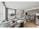 Bright living room with modern decor, hardwood floors, and an open floor plan to the dining area and kitchen at 1238 Coach Station Aly # 101, Raleigh, NC 27601