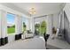 Bright office with large windows overlooking backyard and door to the balcony, modern light fixture at 1238 Coach Station Aly # 101, Raleigh, NC 27601