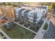 Aerial view of modern townhomes, landscaped grounds, and new construction site at 1242 Coach Station Aly # 101, Raleigh, NC 27601