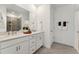 Modern bathroom with double vanity, quartz countertop, and sleek, white cabinetry at 1242 Coach Station Aly # 101, Raleigh, NC 27601